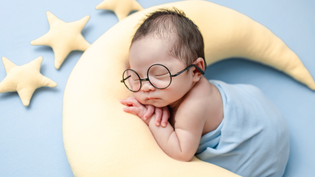 Baby cuddling a moon and stars